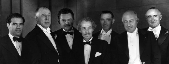Special Award recipient D.W. Griffith, second from left, with, from left: Frank Capra, Griffith, Jean Hersholt, Henry B. Walthall, Frank Lloyd, Cecil B. DeMille, and Donald Crisp.