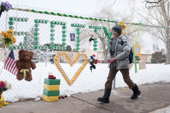 LMI Owen obliviously strides past a memorial